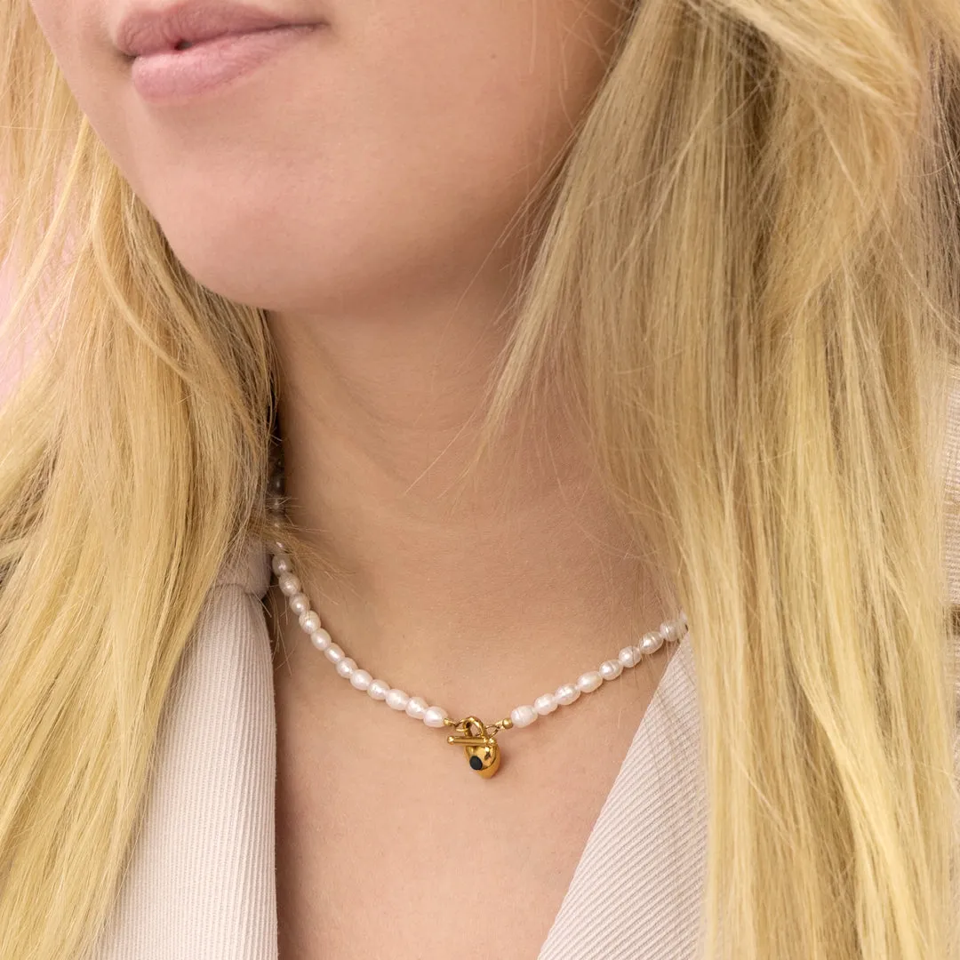 Pearl necklace with gold coloured heart shape closure