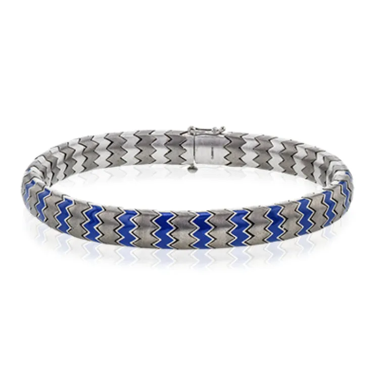 This 14k white gold and titanium men's bracelet features accents of blue enamel within its python-like pattern.